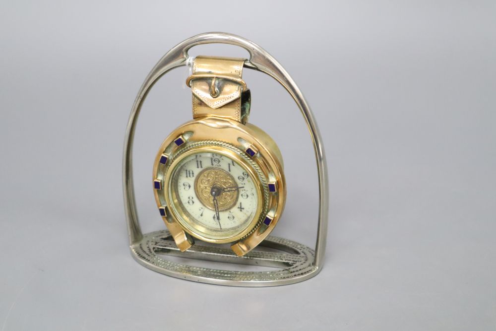 A late Victorian British United Clock Company brass and enamel horseshoe desk timepiece with plated stirrup stand, height 14cm